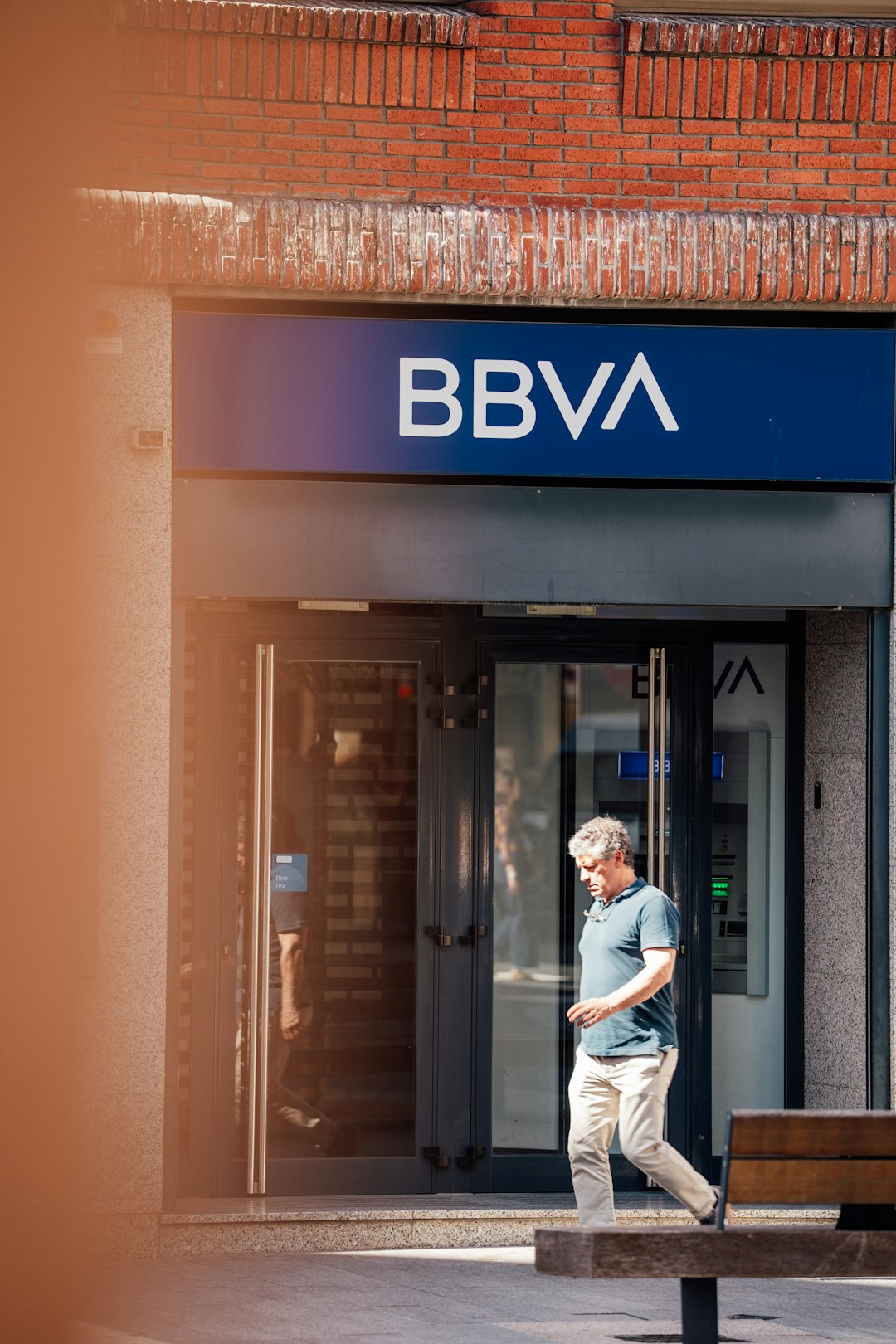man-walks-past-a-bbva-bank-entrance-gtja7oiklse